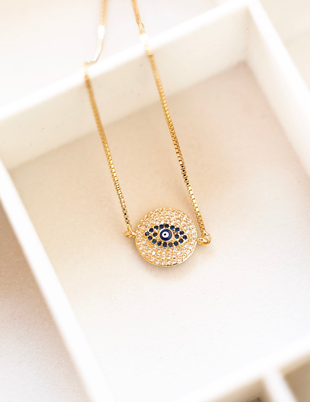 AMARA Bracelet featuring an adjustable bolo design with a colorful cubic zirconia evil eye charm, elegantly crafted in 18K gold plated brass.