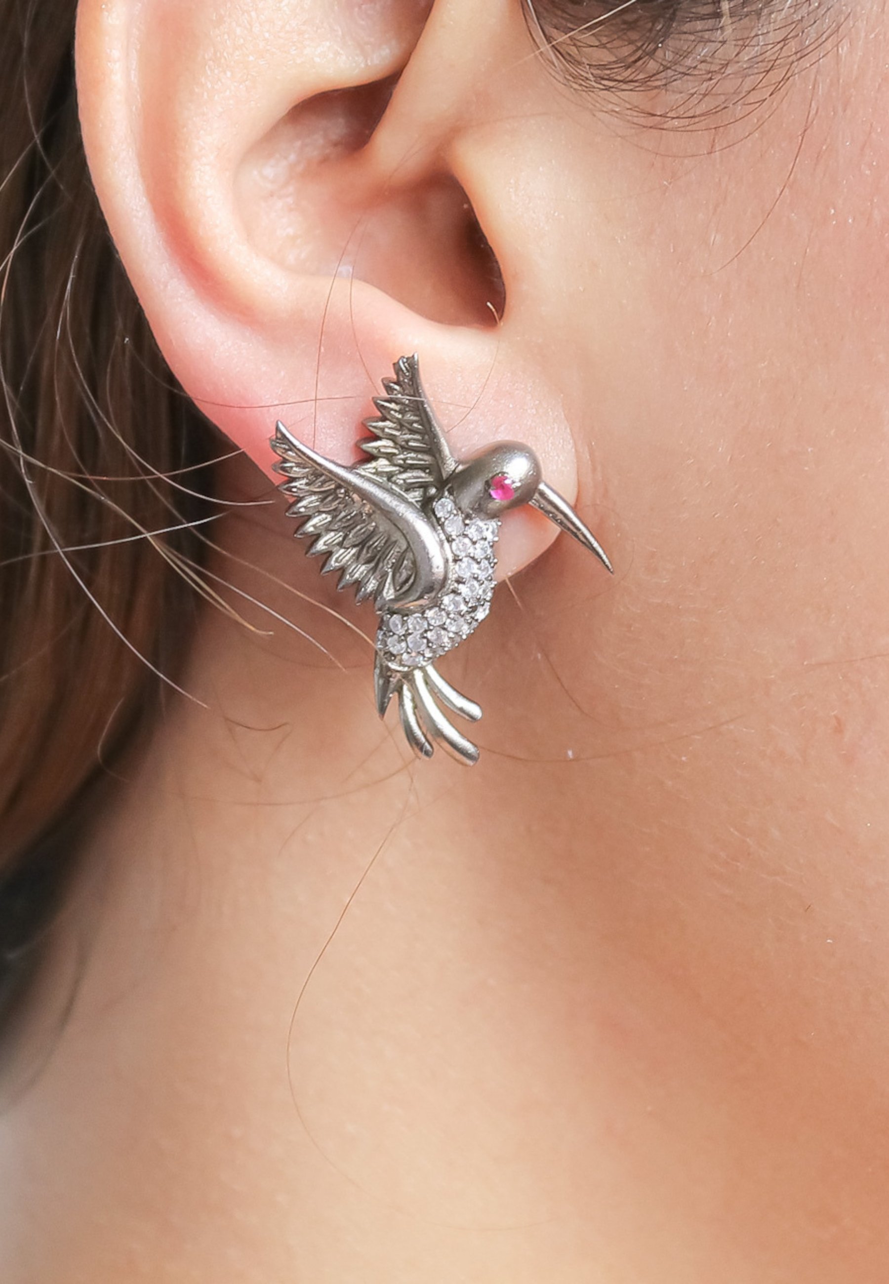 Elegant Amazonian Hummingbird Stud Earrings in gold plating with zircon stones and garnet eye, showcasing a delicate bird design.