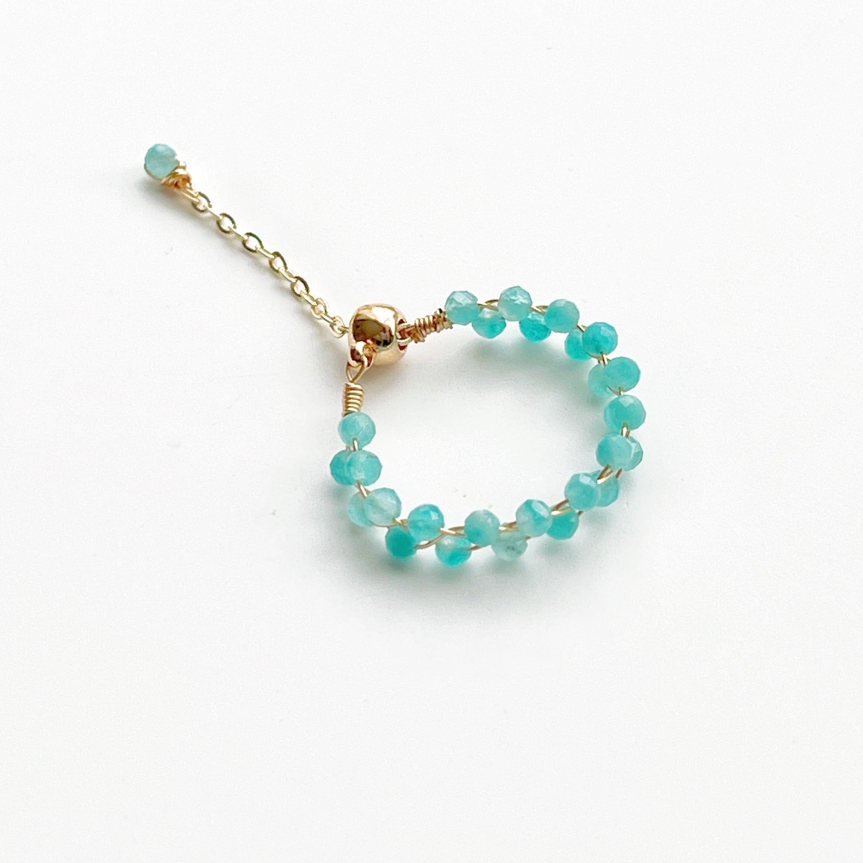 A beautiful Amazonite Beaded Adjustable Ring featuring natural green gemstone beads on a gold-plated bronze wire, showcasing its unique craftsmanship.