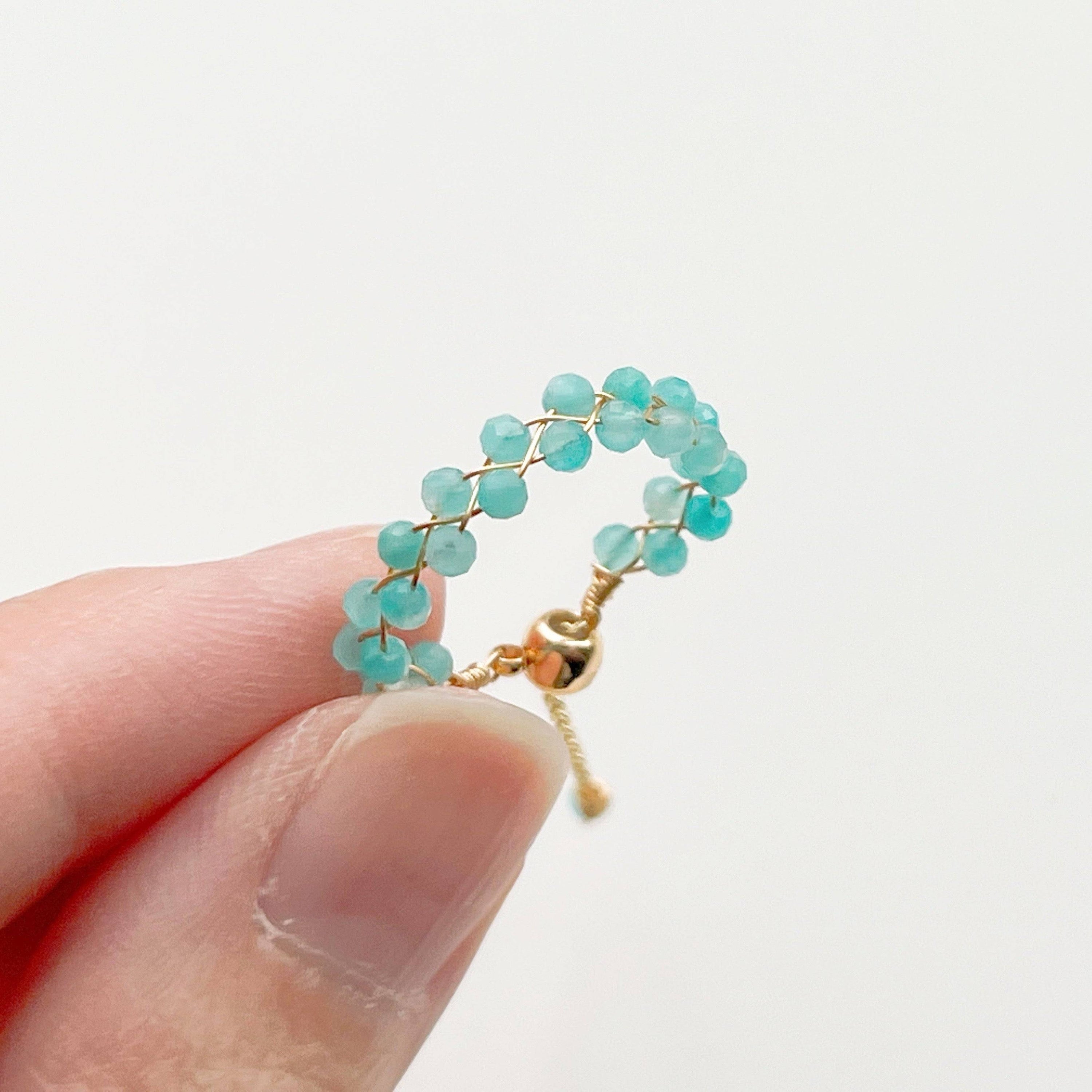 A beautiful Amazonite Beaded Adjustable Ring featuring natural green gemstone beads on a gold-plated bronze wire, showcasing its unique craftsmanship.