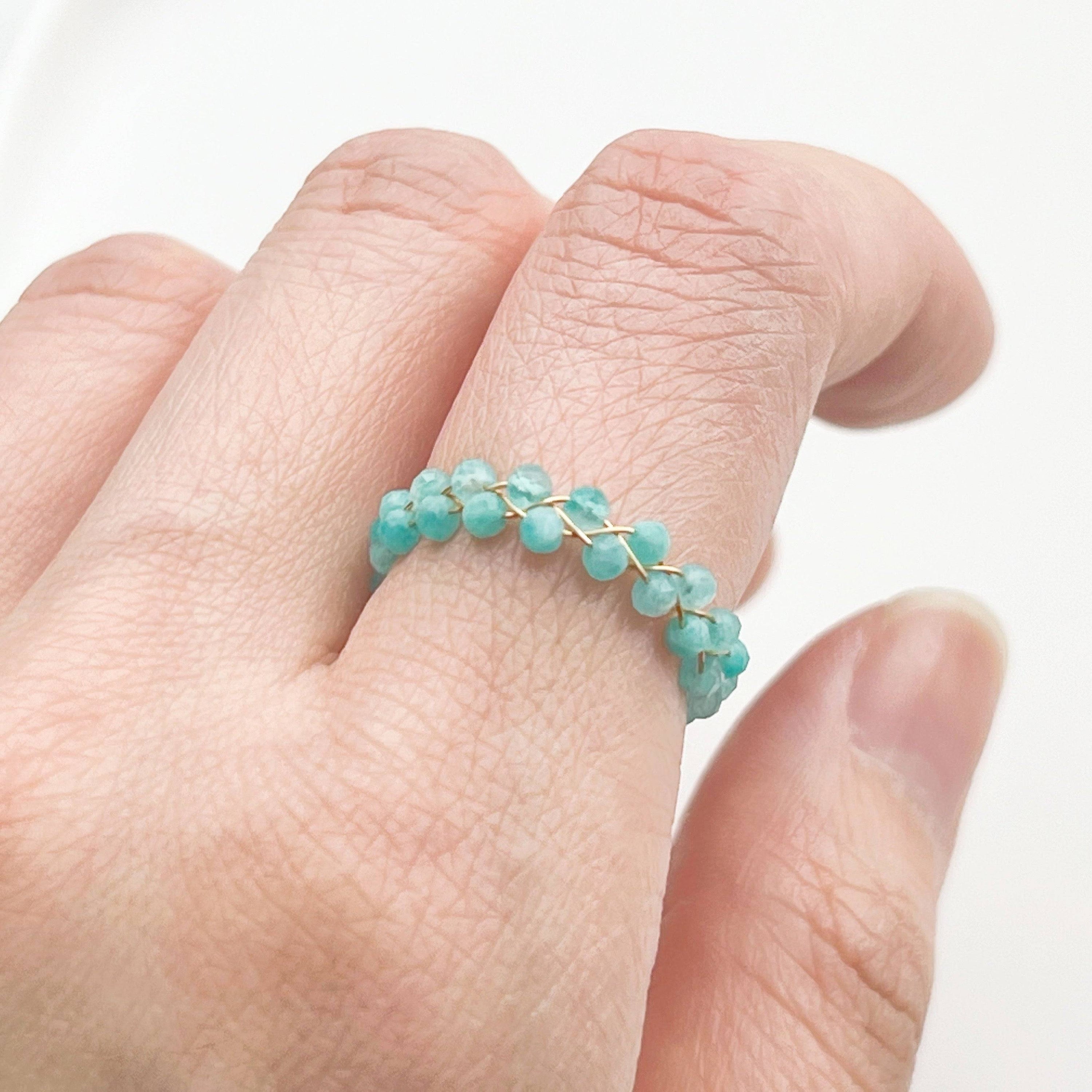 A beautiful Amazonite Beaded Adjustable Ring featuring natural green gemstone beads on a gold-plated bronze wire, showcasing its unique craftsmanship.