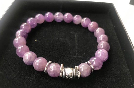 A beautiful handmade Amethyst Bracelet featuring 8mm purple amethyst gemstone beads, showcasing its elegant design and healing properties.