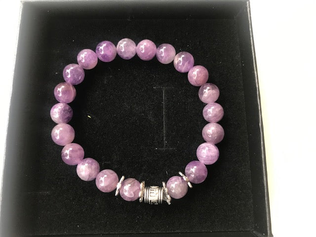 A beautiful handmade Amethyst Bracelet featuring 8mm purple amethyst gemstone beads, showcasing its elegant design and healing properties.