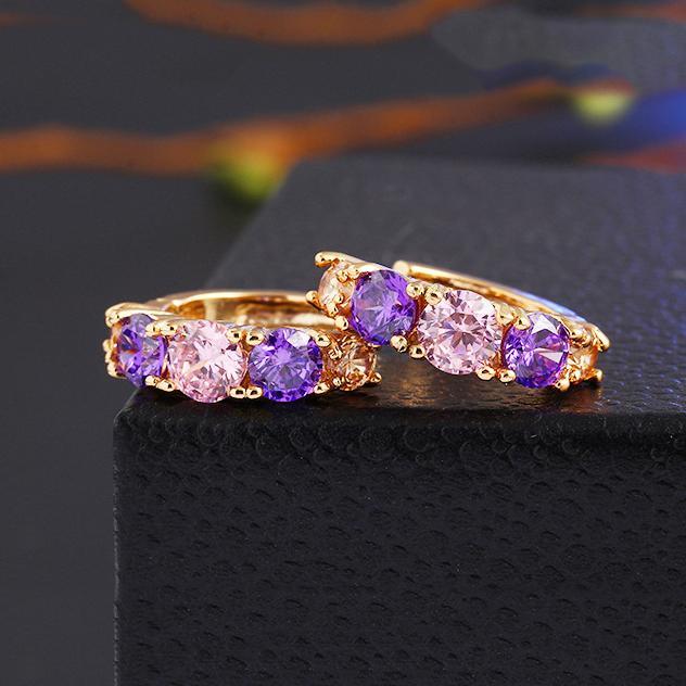 Elegant Amethyst Multistone Huggie Earrings featuring Austrian Crystals, crafted in 18K gold plating, showcasing a luxurious and stylish design.