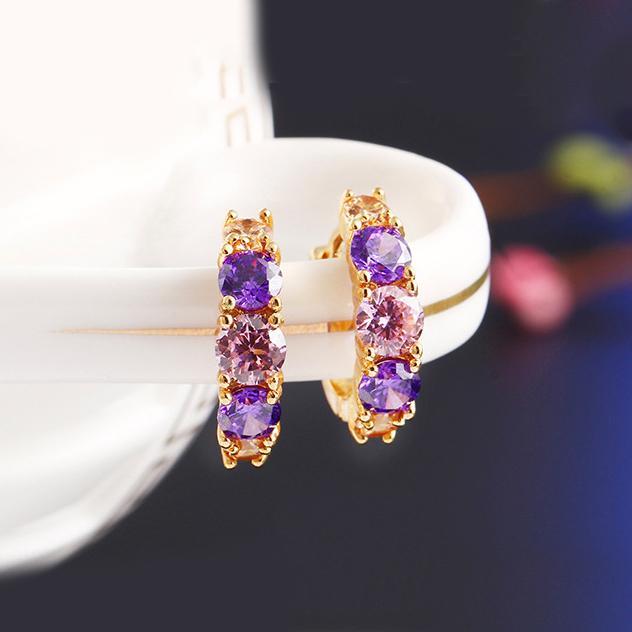 Elegant Amethyst Multistone Huggie Earrings featuring Austrian Crystals, crafted in 18K gold plating, showcasing a luxurious and stylish design.