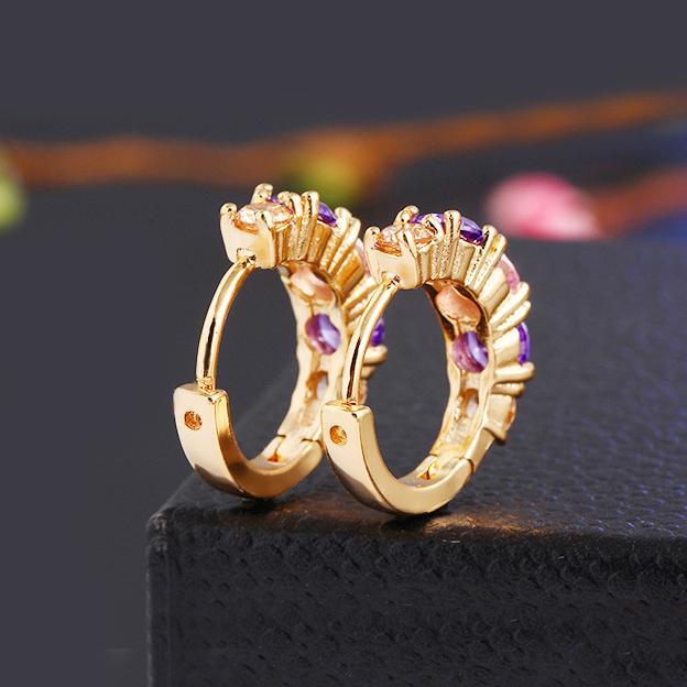 Elegant Amethyst Multistone Huggie Earrings featuring Austrian Crystals, crafted in 18K gold plating, showcasing a luxurious and stylish design.