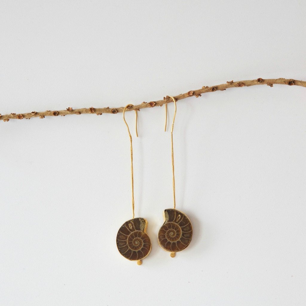 Elegant Ammonite Earrings with 18K gold plating, showcasing unique fossilized stone design, handcrafted in India.