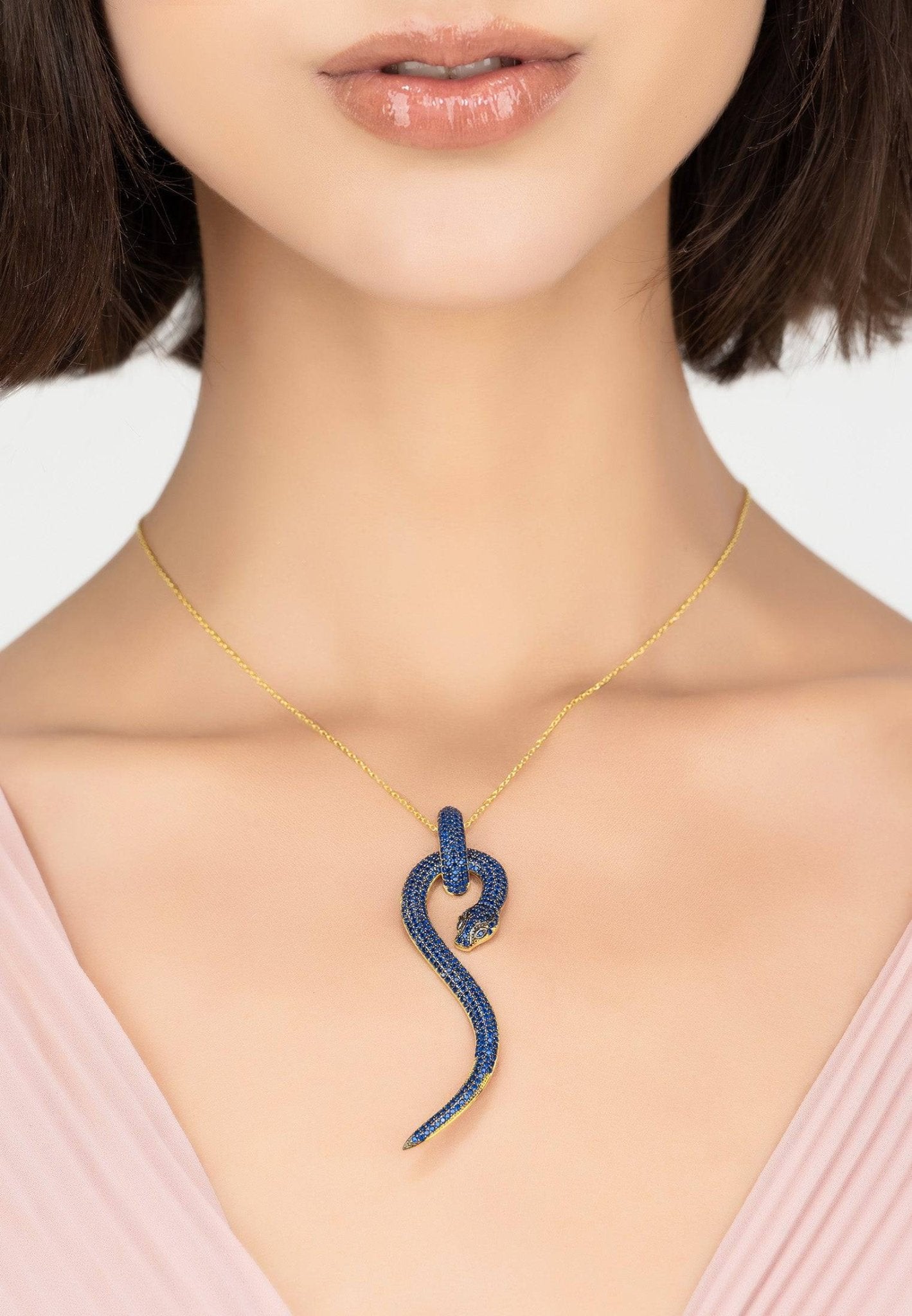 Anaconda Snake Pendant Necklace in gold with sapphire zircons, featuring a unique snake design and adjustable length.