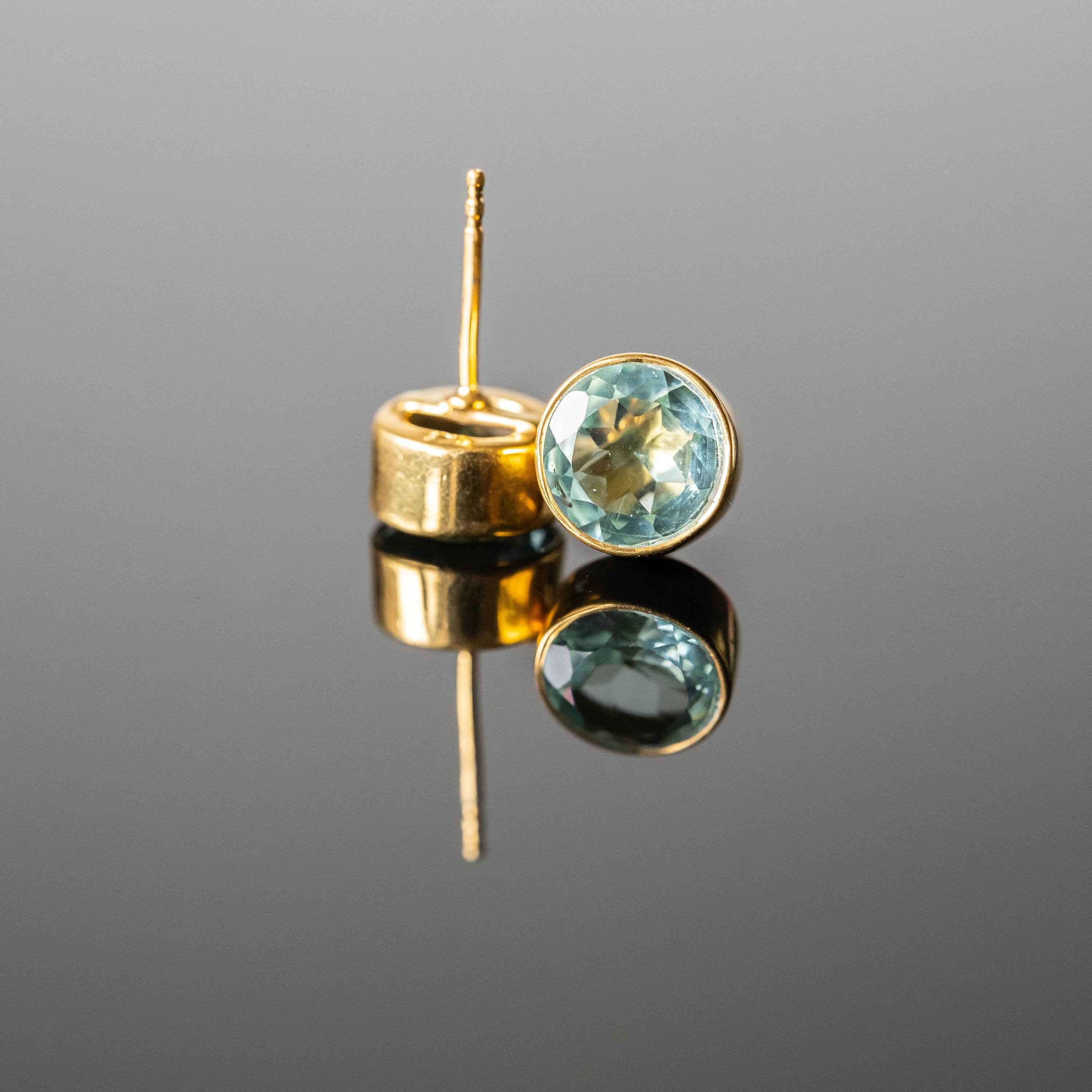 Andrea Aquamarine Round Studs featuring green tone aquamarine stones set in gold-plated 925 sterling silver, elegantly designed for any occasion.