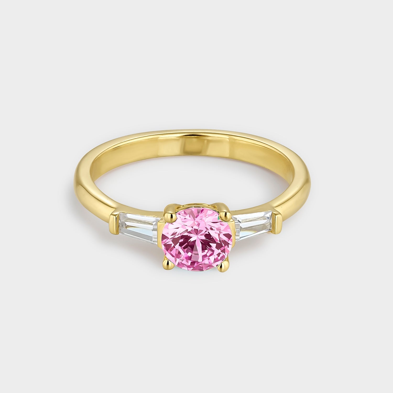 Anillo trío con circonitas rosa y blancas, bañado en oro amarillo de 18K, elegante y brillante.