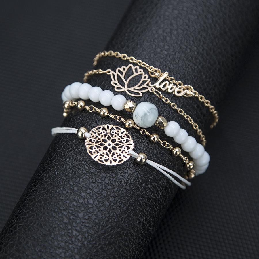 Arcoris White Marble Filigree Pendant and Love Bracelet Set featuring 14K gold plating and celestial design.