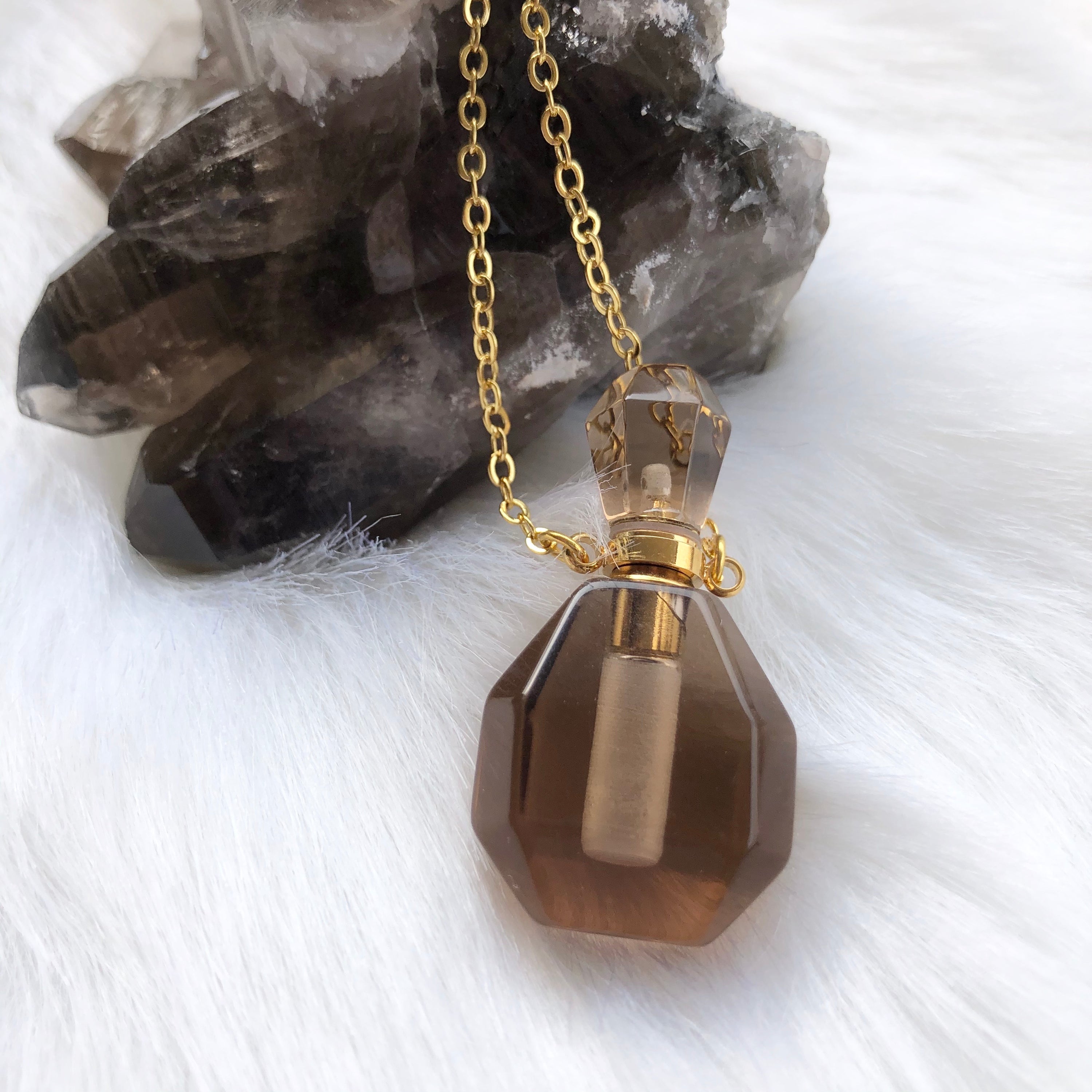 Aroma Gem Necklace featuring a gold plated chain and a crystal pendant designed for essential oil infusion.
