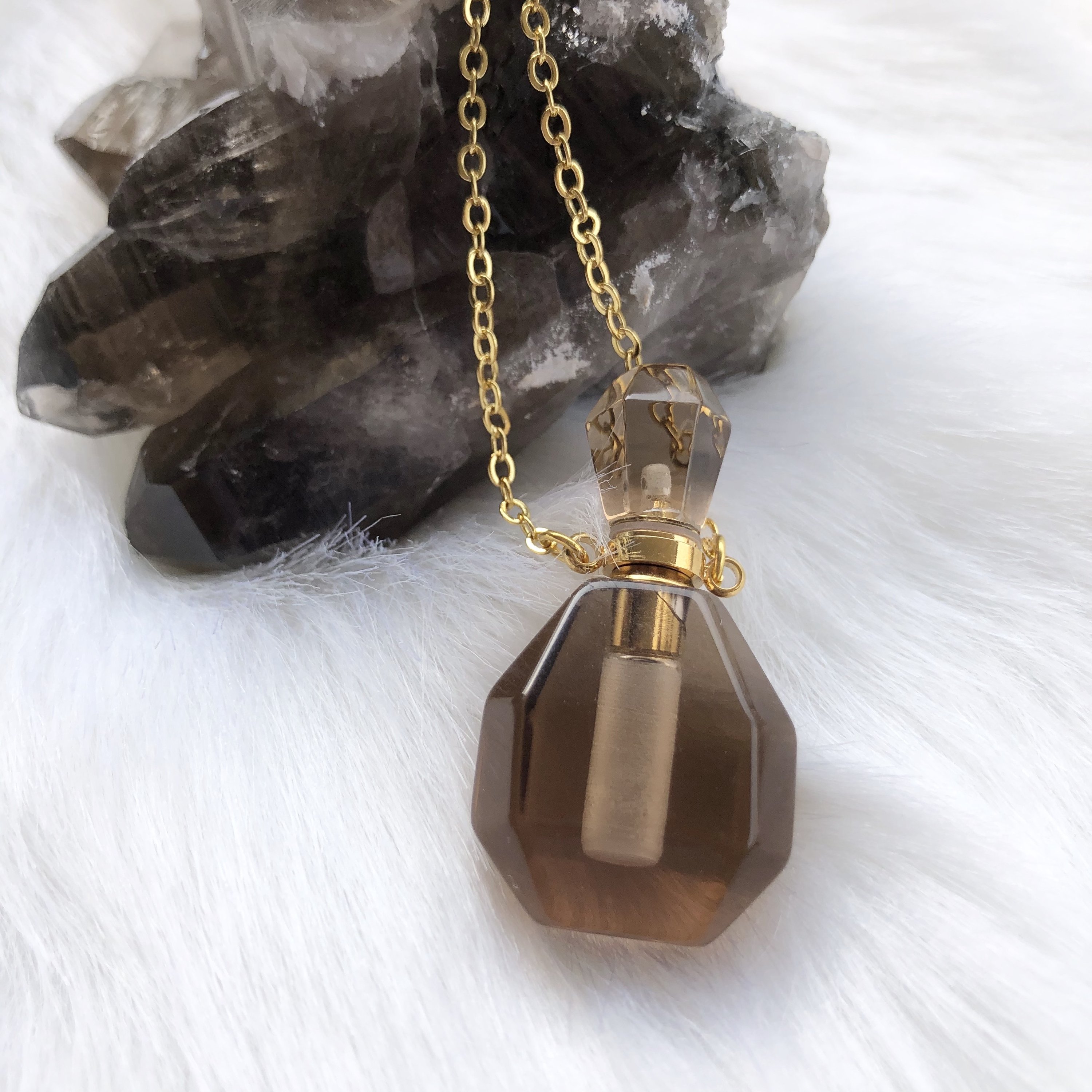 Aroma Gem Necklace featuring a gold plated chain and a crystal pendant designed for essential oil infusion.