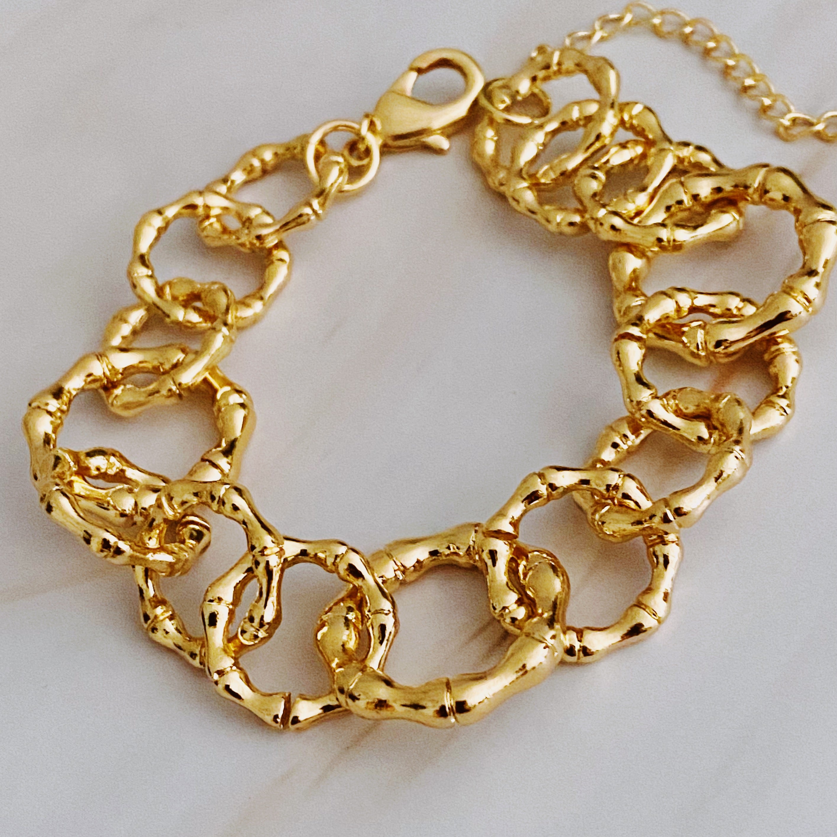 Artfully Linked Chain Bracelet featuring polished gold finish and unique link design, perfect for stylish accessorizing.