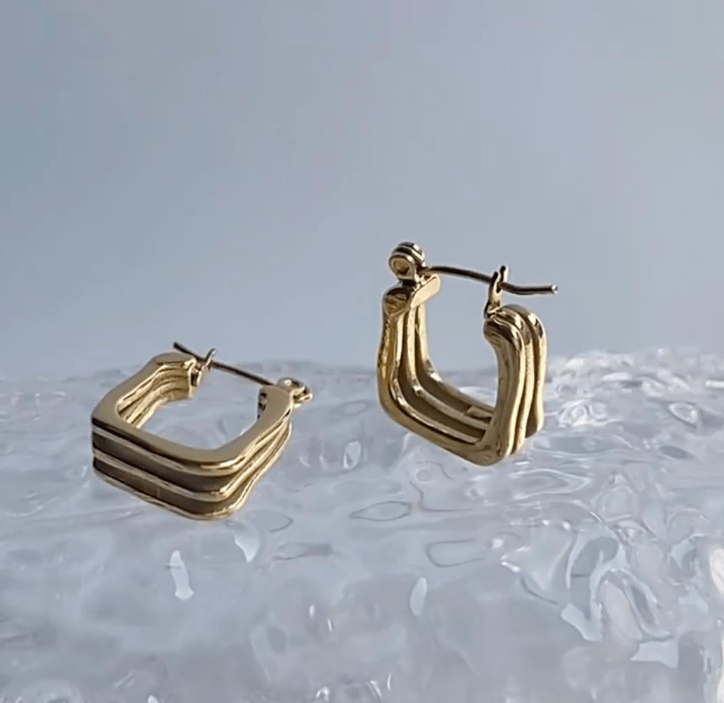 Arwin Triple Hoop Earrings in Gold, showcasing a unique triple hoop design with a shiny gold finish.