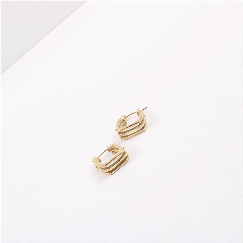 Arwin Triple Hoop Earrings in Gold, showcasing a unique triple hoop design with a shiny gold finish.