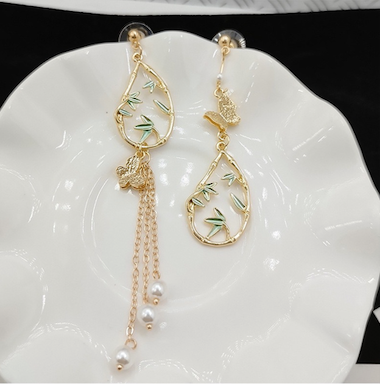 Asymmetric earrings featuring butterfly and bamboo designs adorned with artificial pearls, crafted from S925 alloy.