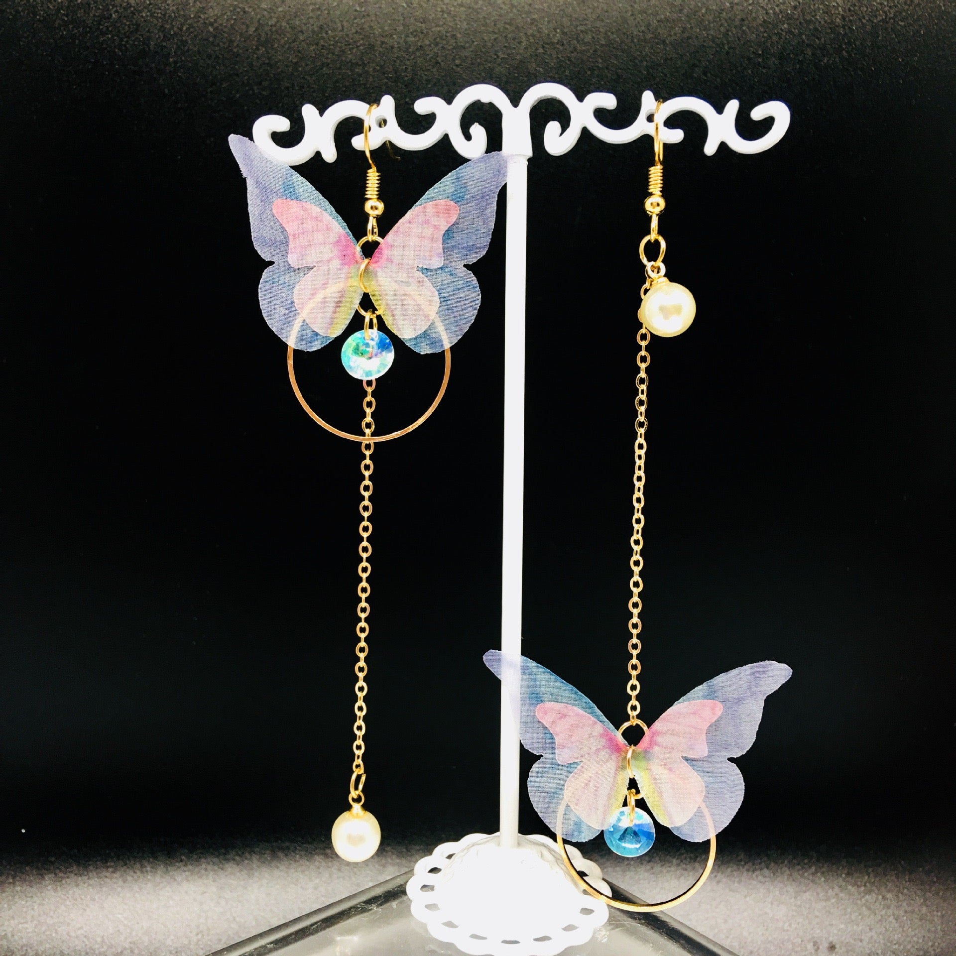 Asymmetric butterfly-on-hoop earrings featuring alloy, fabric, and artificial pearls, showcasing a unique and elegant design.