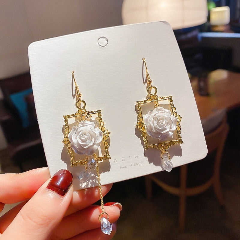 Asymmetric earrings featuring a rose in a photo frame with pearl tassels, crafted from alloy and S925 silver.