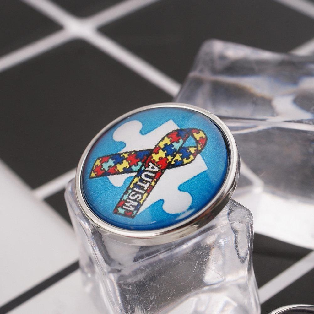 A vibrant Autism Awareness Snap featuring a colorful Autism Ribbon design, perfect for jewelry customization.
