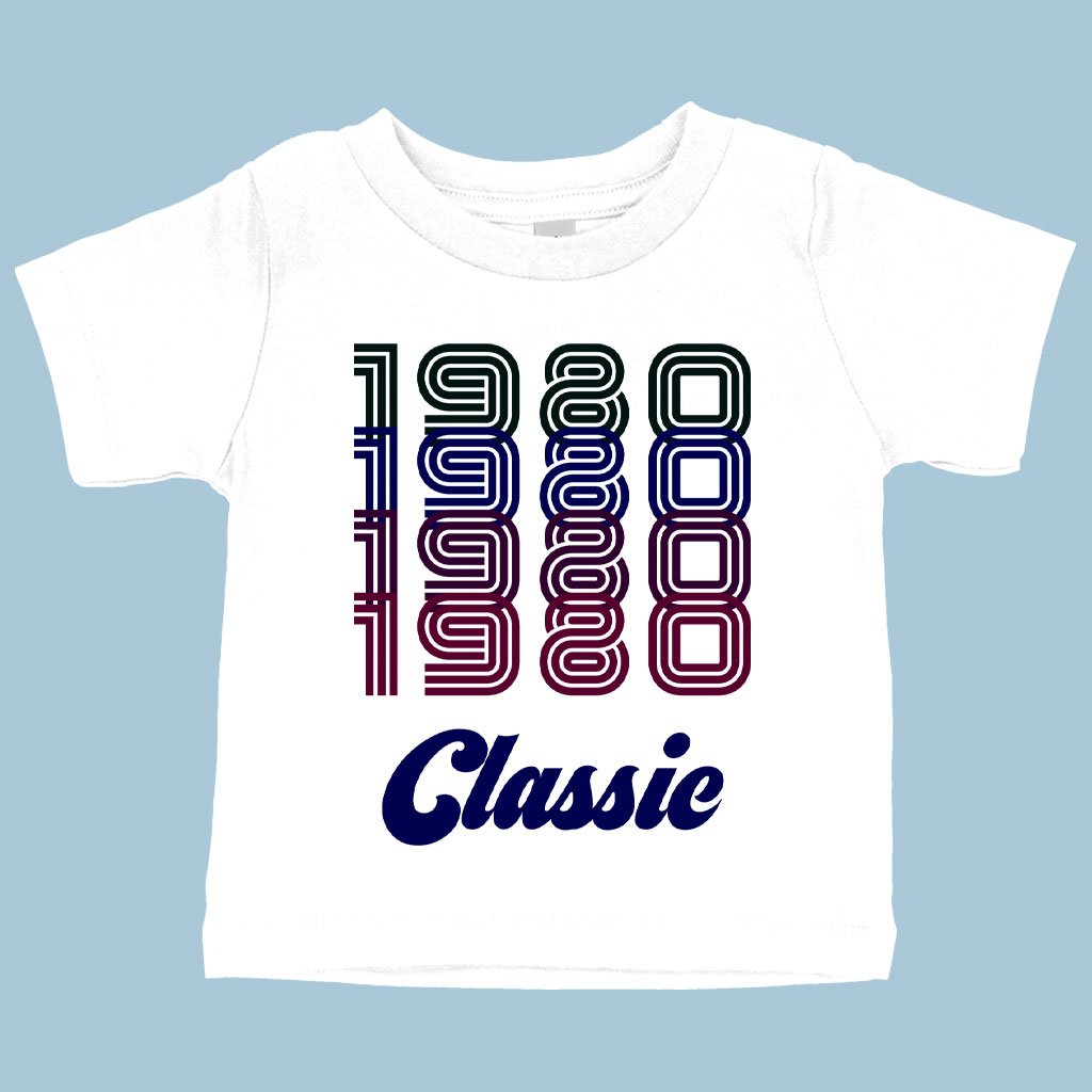 Baby wearing a soft and stylish Baby 1980 Classic T-Shirt, showcasing a retro 80s design with a crew neck and short sleeves.