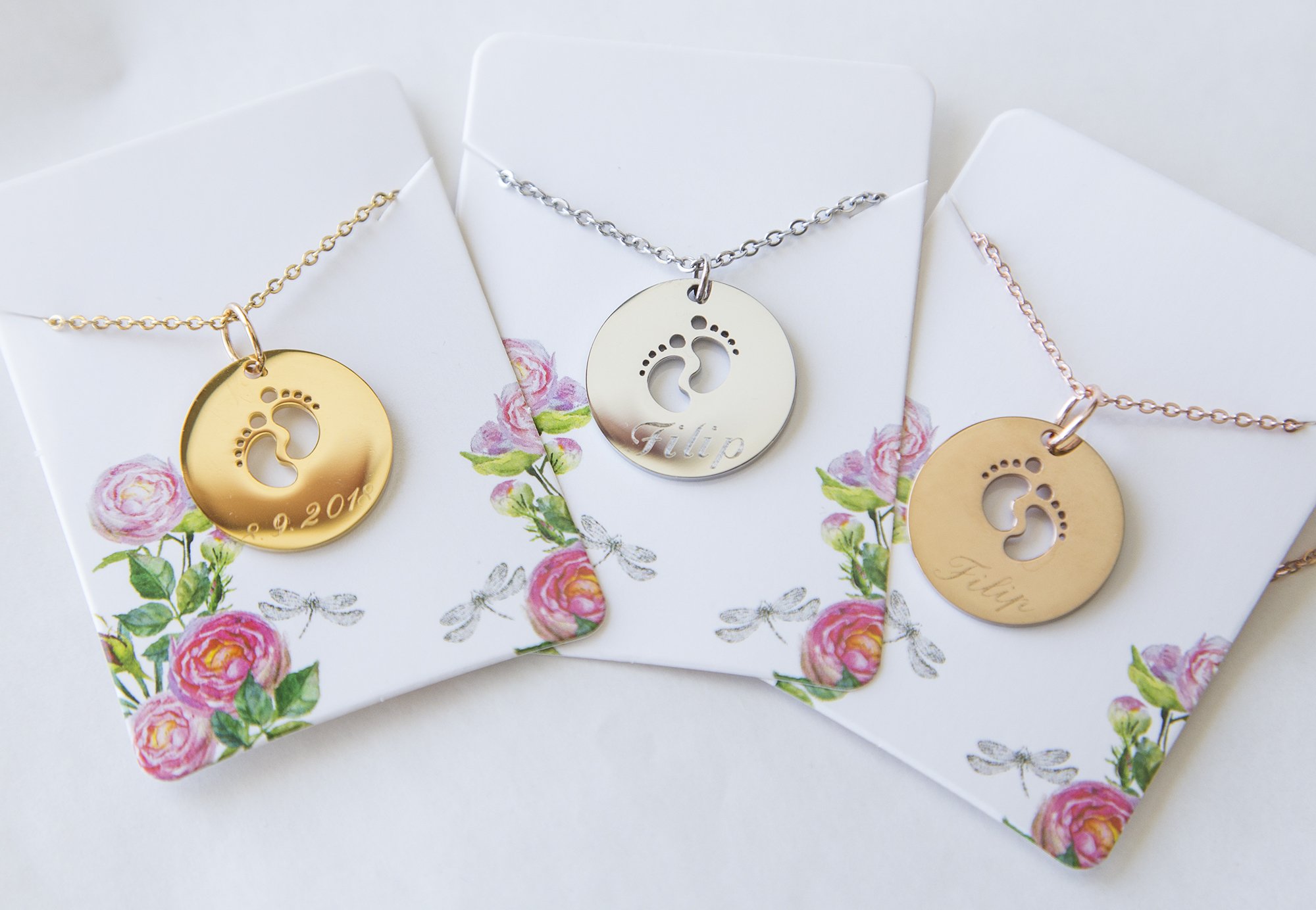 A beautiful stainless steel necklace featuring a baby feet pendant, customizable with engraving for new moms.