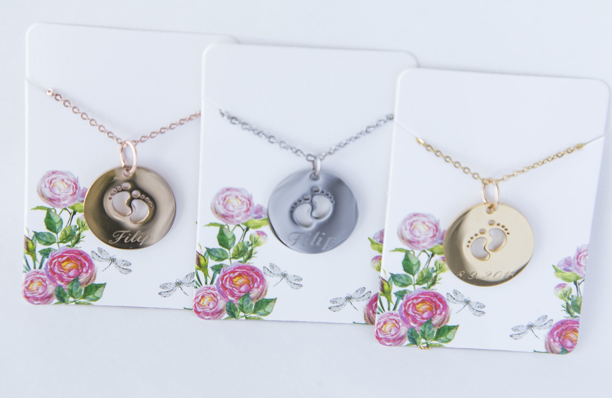 A beautiful stainless steel necklace featuring a baby feet pendant, customizable with engraving for new moms.