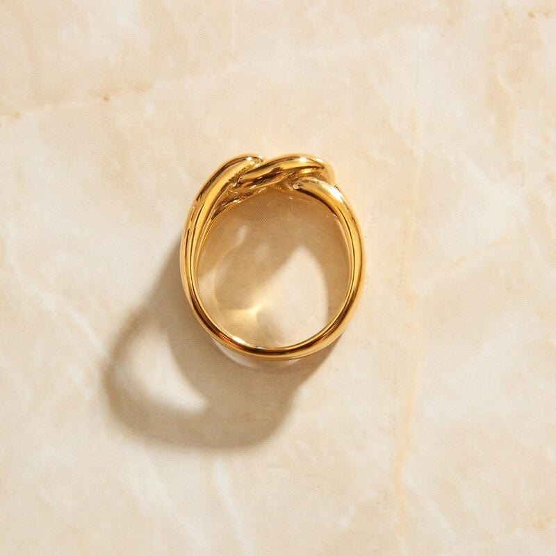 Bailey Intertwined Knot Ring in 18Kt yellow gold, showcasing its sleek design and durable stainless steel construction.