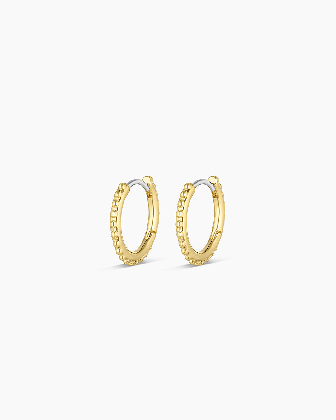 A pair of Bali Huggies earrings, designed to hug the ears comfortably with a sleek and stylish appearance.