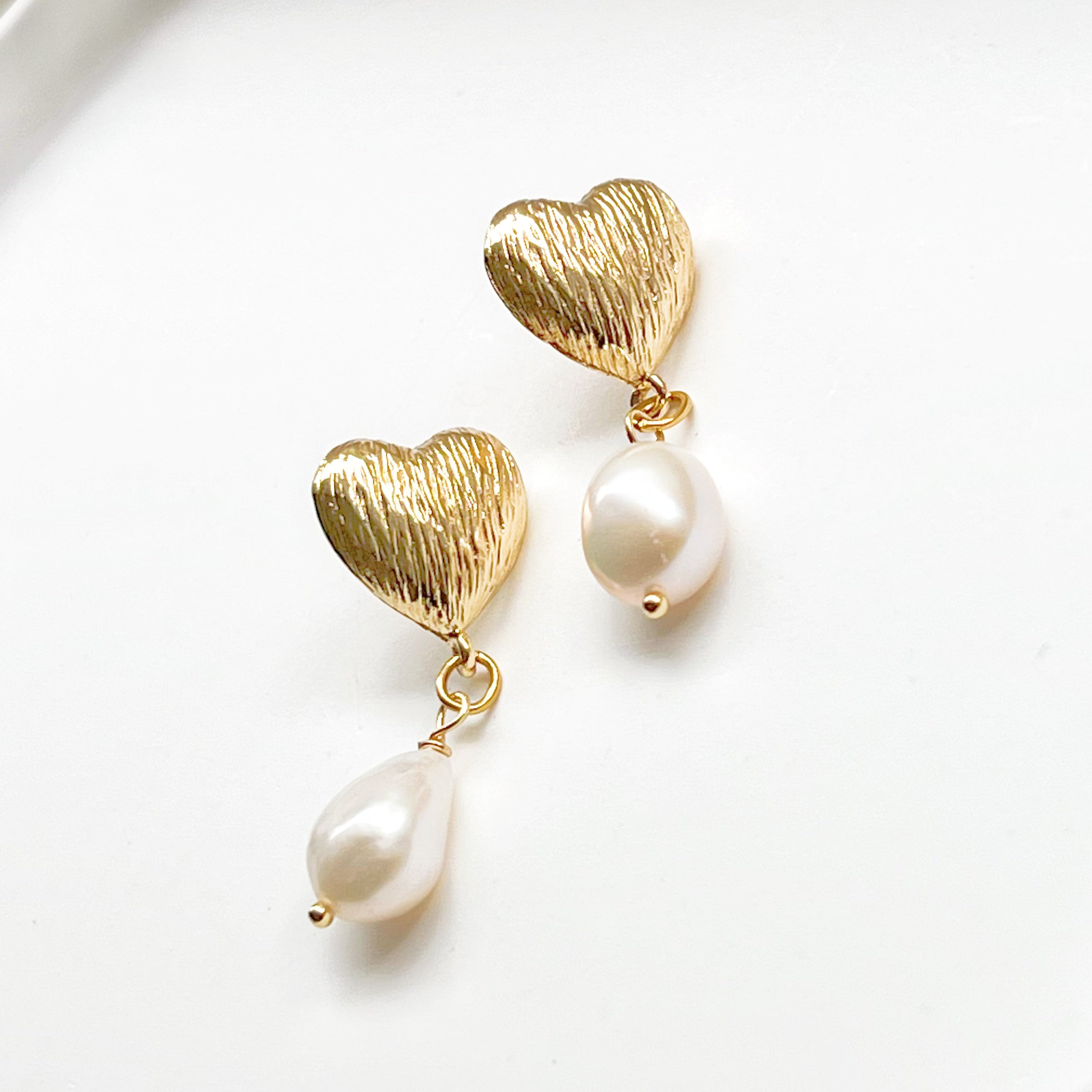 Elegant Baroque Pearl and Gold Heart Earrings showcasing unique teardrop pearls and gold-plated studs.