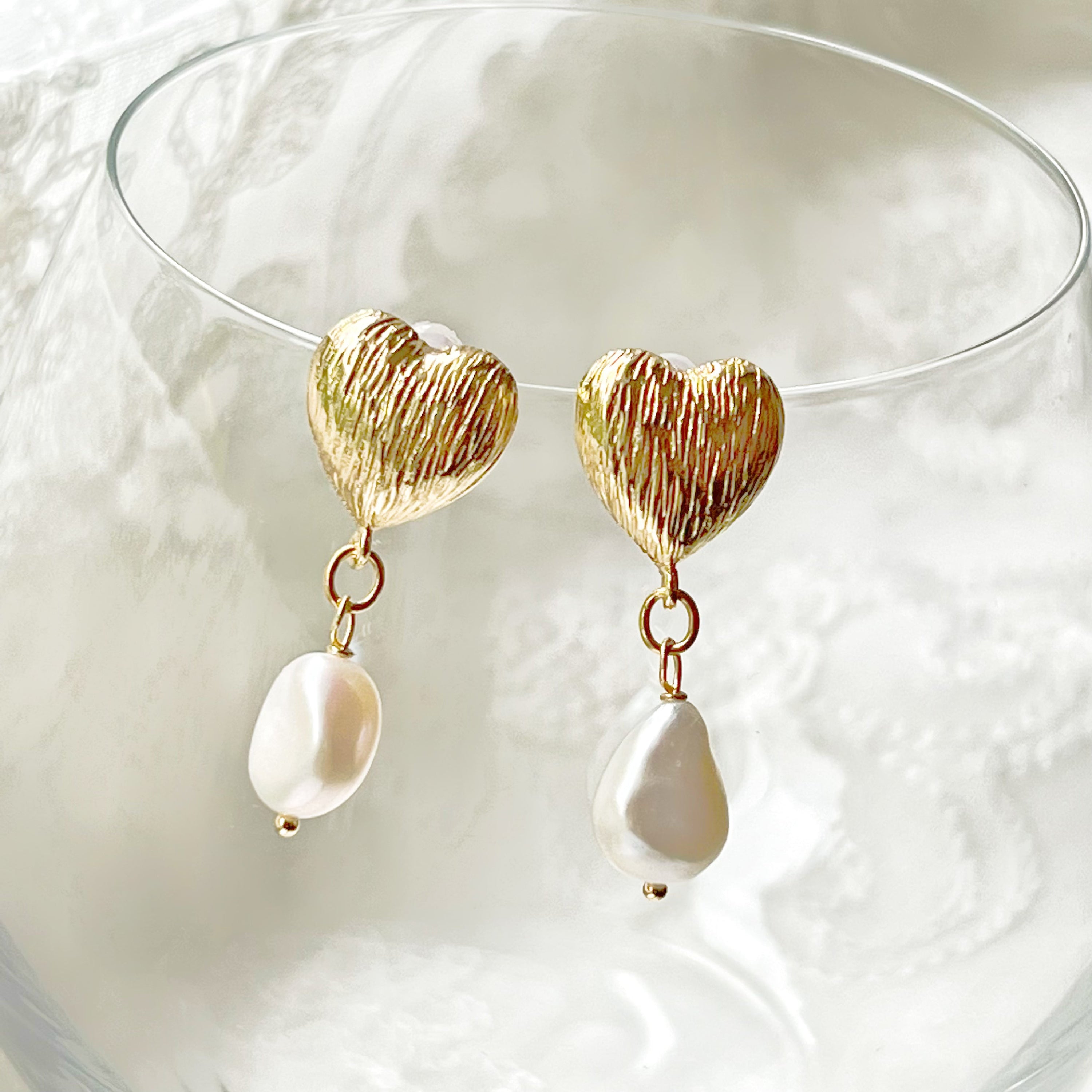 Elegant Baroque Pearl and Gold Heart Earrings showcasing unique teardrop pearls and gold-plated studs.