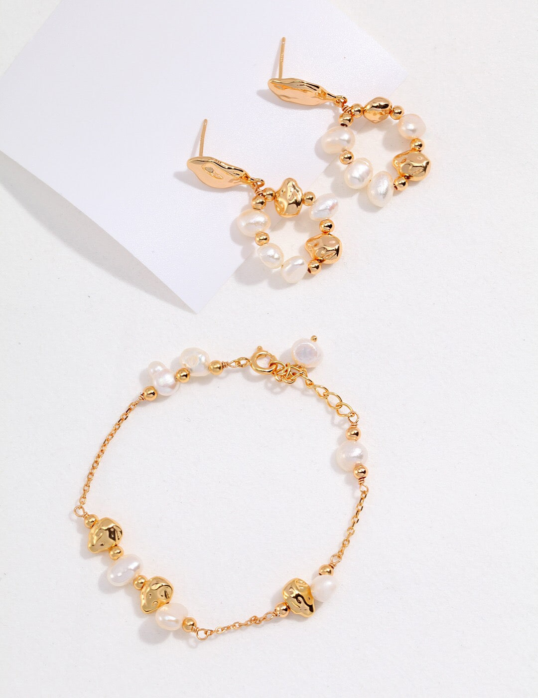 A handmade Baroque Pearl and Irregular Gold Ball Bracelet featuring natural pearls and gold vermeil, elegantly displayed on a soft surface.