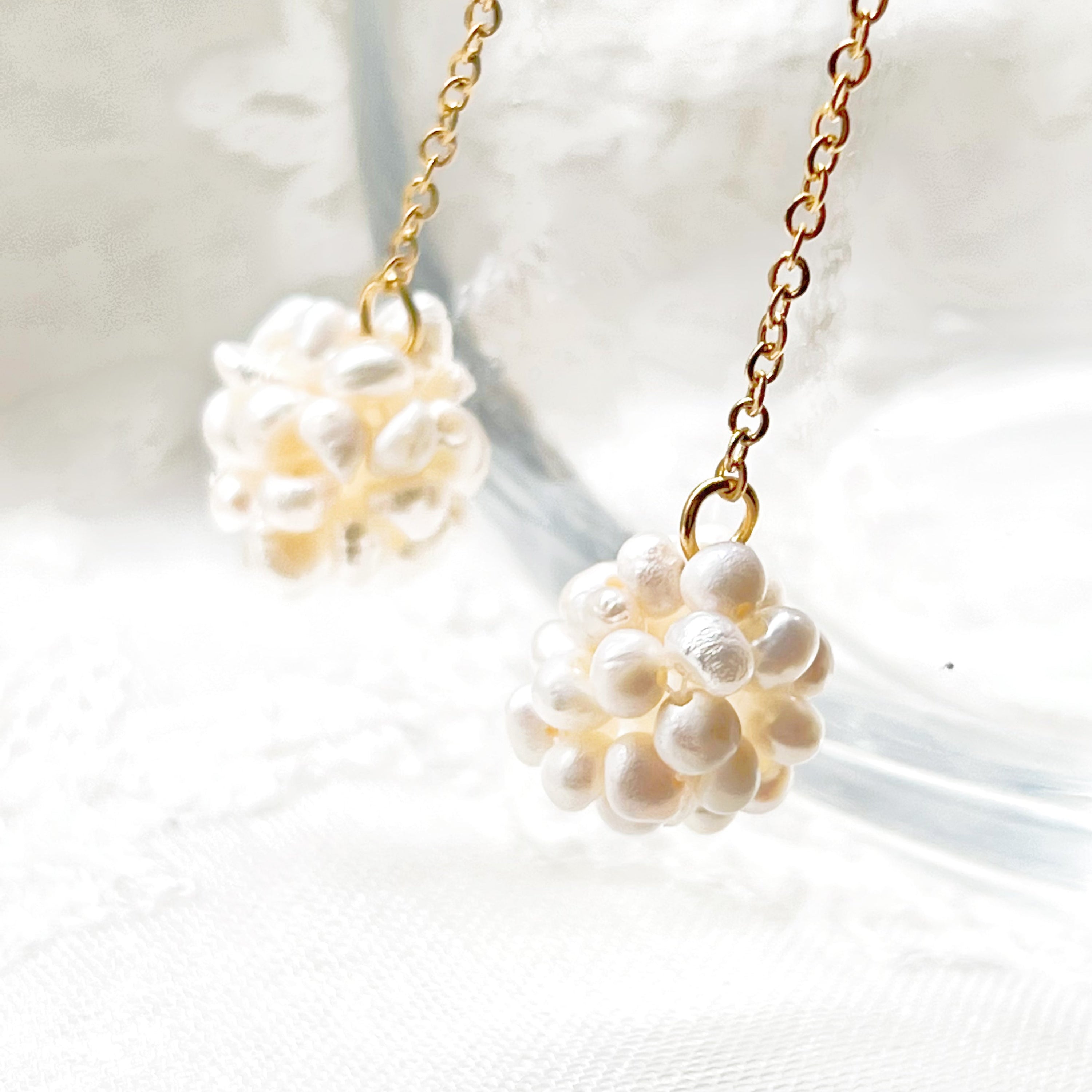 Elegant baroque pearl long drop earrings featuring freshwater pearls and sterling silver studs, showcasing unique shapes and a luxurious design.