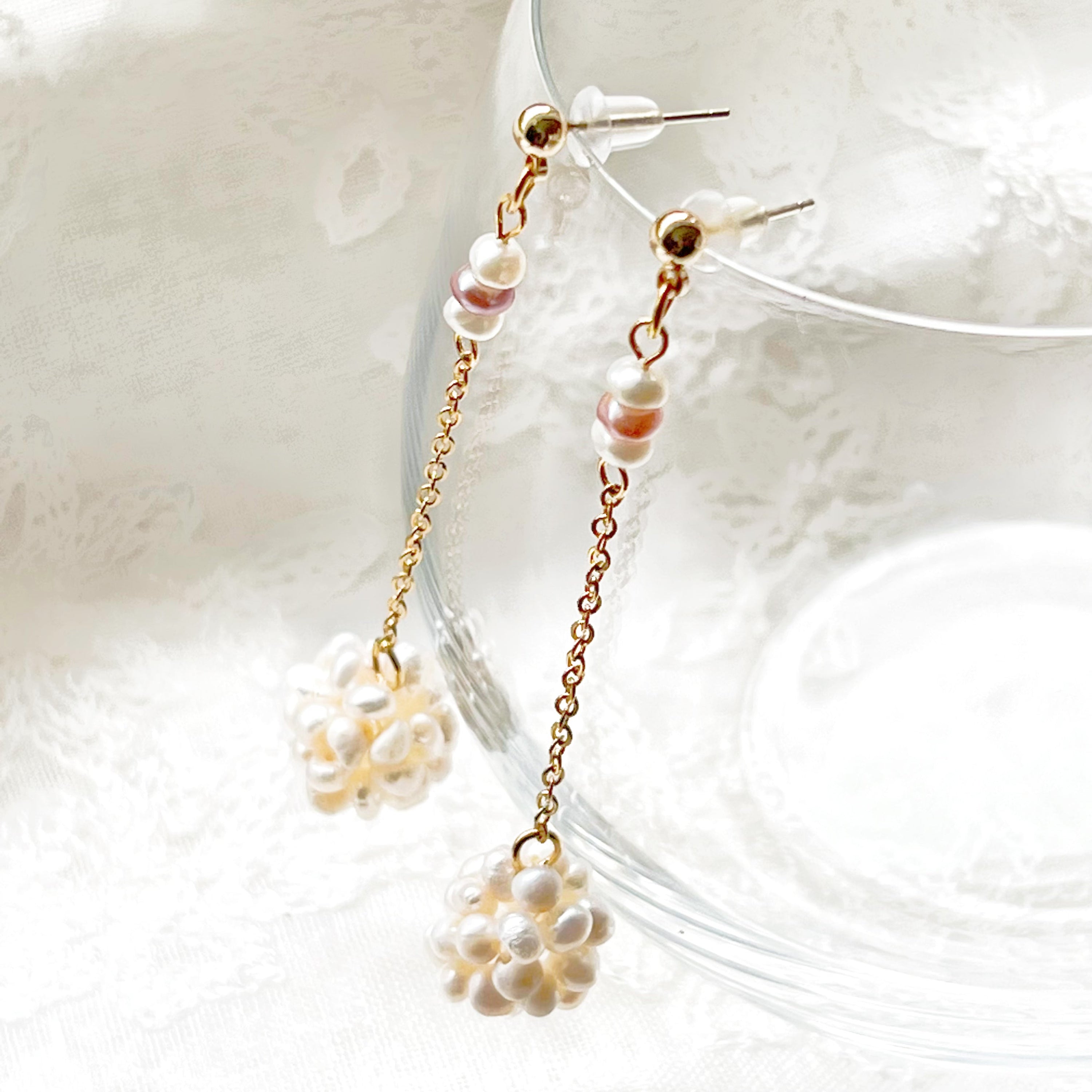 Elegant baroque pearl long drop earrings featuring freshwater pearls and sterling silver studs, showcasing unique shapes and a luxurious design.