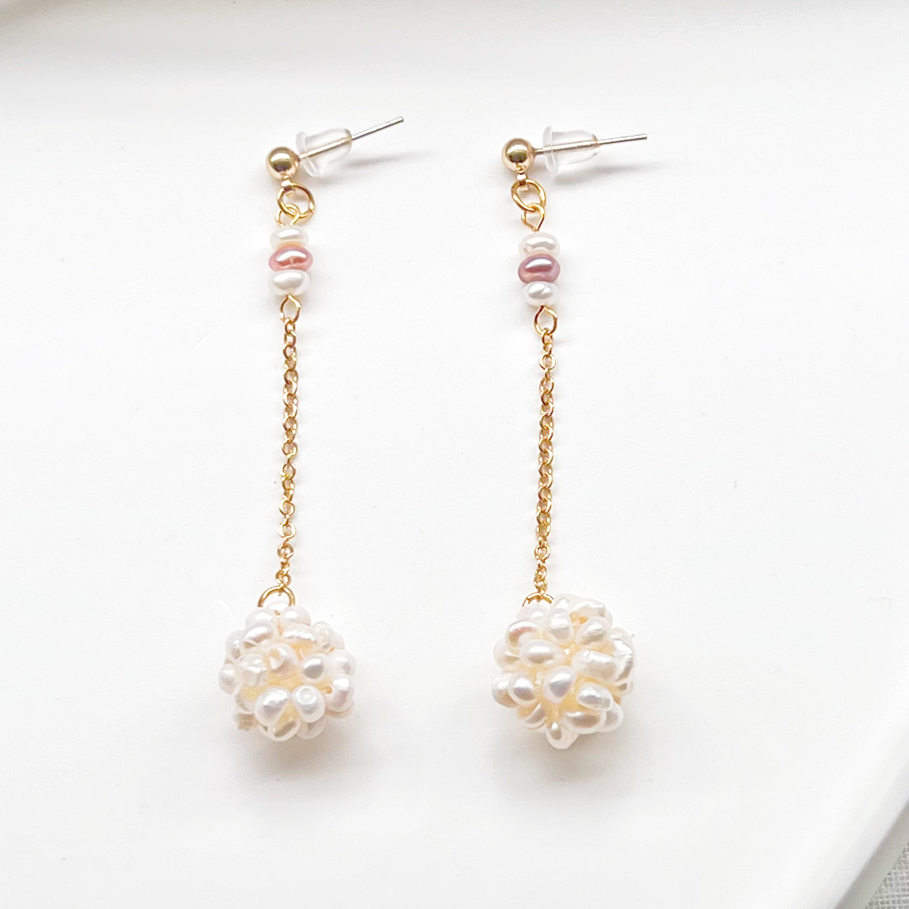 Elegant baroque pearl long drop earrings featuring freshwater pearls and sterling silver studs, showcasing unique shapes and a luxurious design.