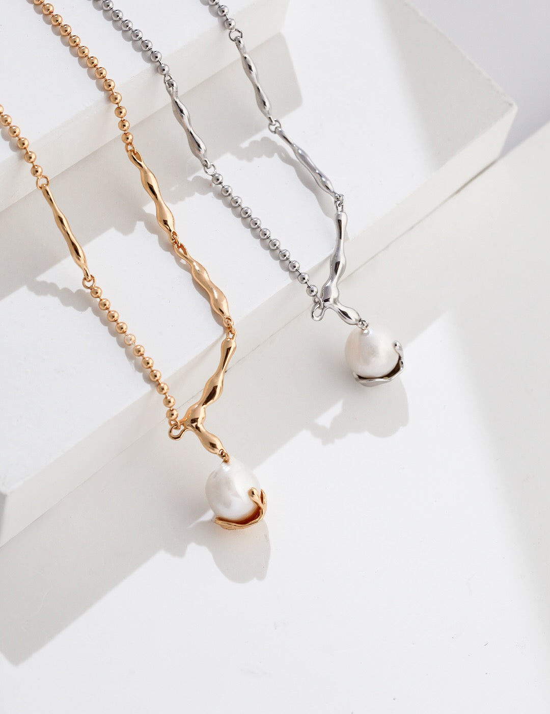 A stunning Baroque Pearl Pendant Necklace featuring unique freshwater pearls and gold vermeil chain, elegantly displayed on a soft background.