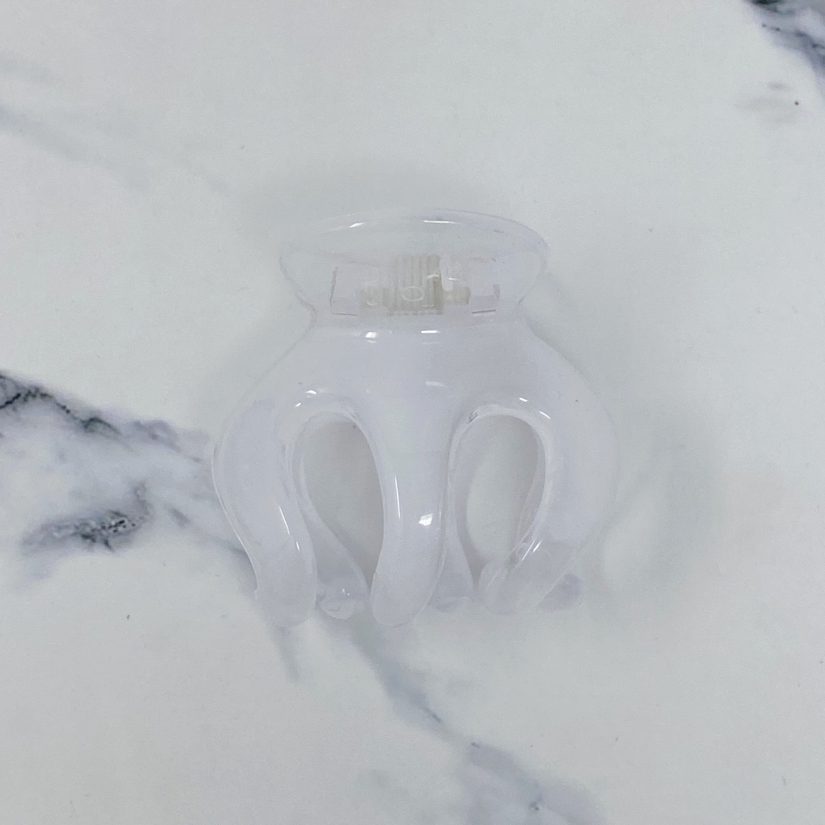 A set of translucent acrylic hair claws in various colors, perfect for beach hairstyles.