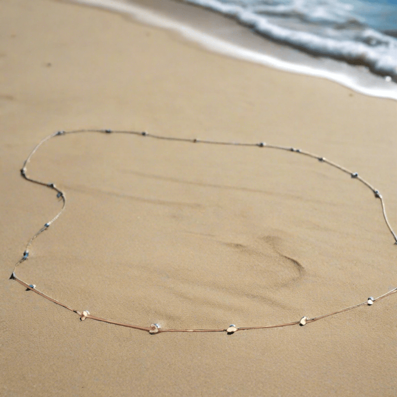 A beautiful Beachy Belly Waist Chain featuring sparkling rhinestones and golden balls, perfect for beach or casual wear.