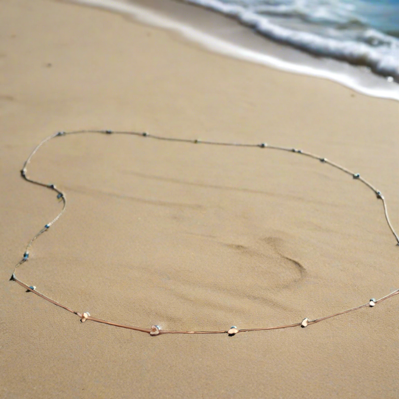 A beautiful Beachy Belly Waist Chain featuring sparkling rhinestones and golden balls, perfect for beach or casual wear.