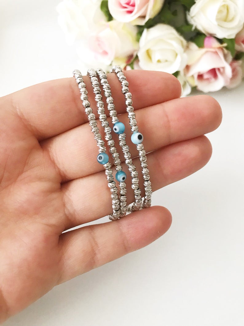 Beaded Evil Eye Bracelet featuring tiny evil eye beads on a rose gold and silver chain, showcasing its adjustable design and handmade craftsmanship.