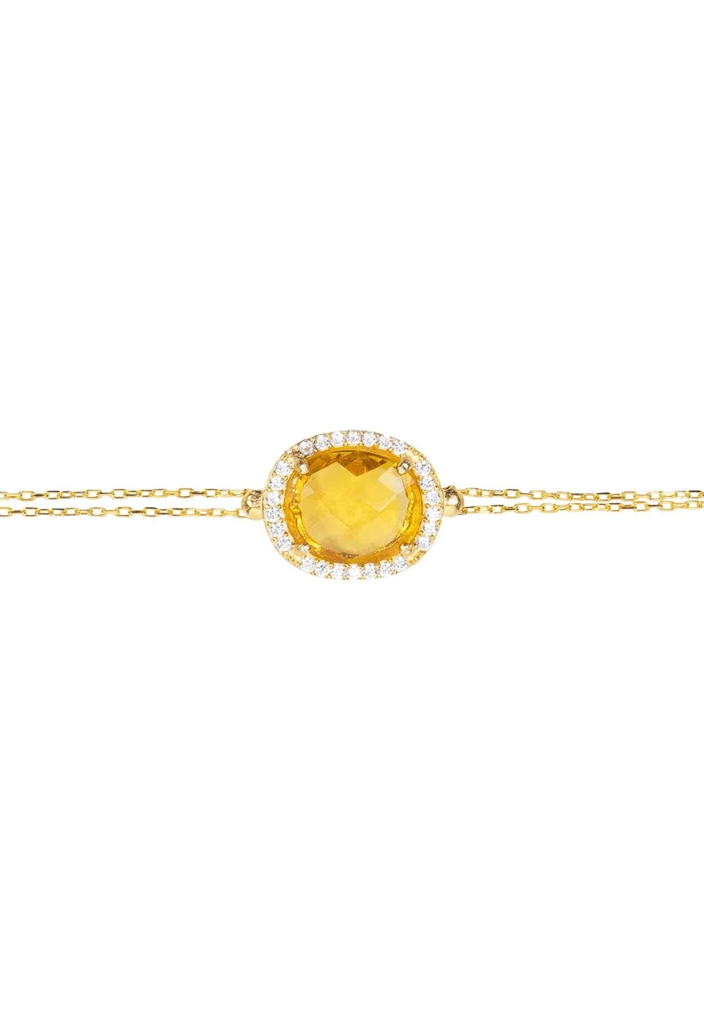 Beatrice Oval Gemstone Bracelet featuring a vibrant citrine surrounded by cubic zirconia on a gold plated double chain.