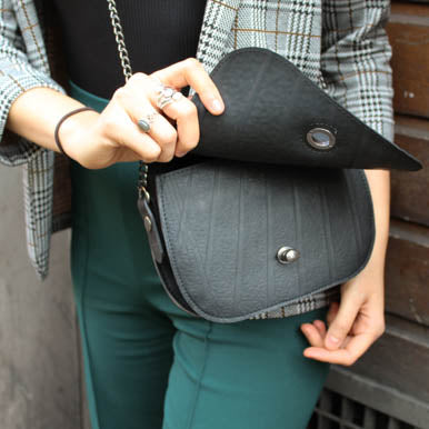 Becca Classic Black Vegan Saddle Bag made from recycled inner tubes, featuring unique patterns and grey velvet lining.