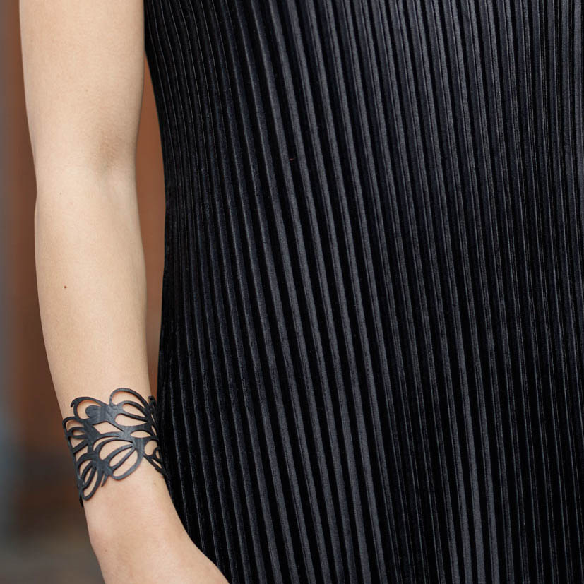 Bella Elegant Inner Tube Art Nouveau Bracelet handcrafted from recycled rubber, featuring a delicate design and button closure.