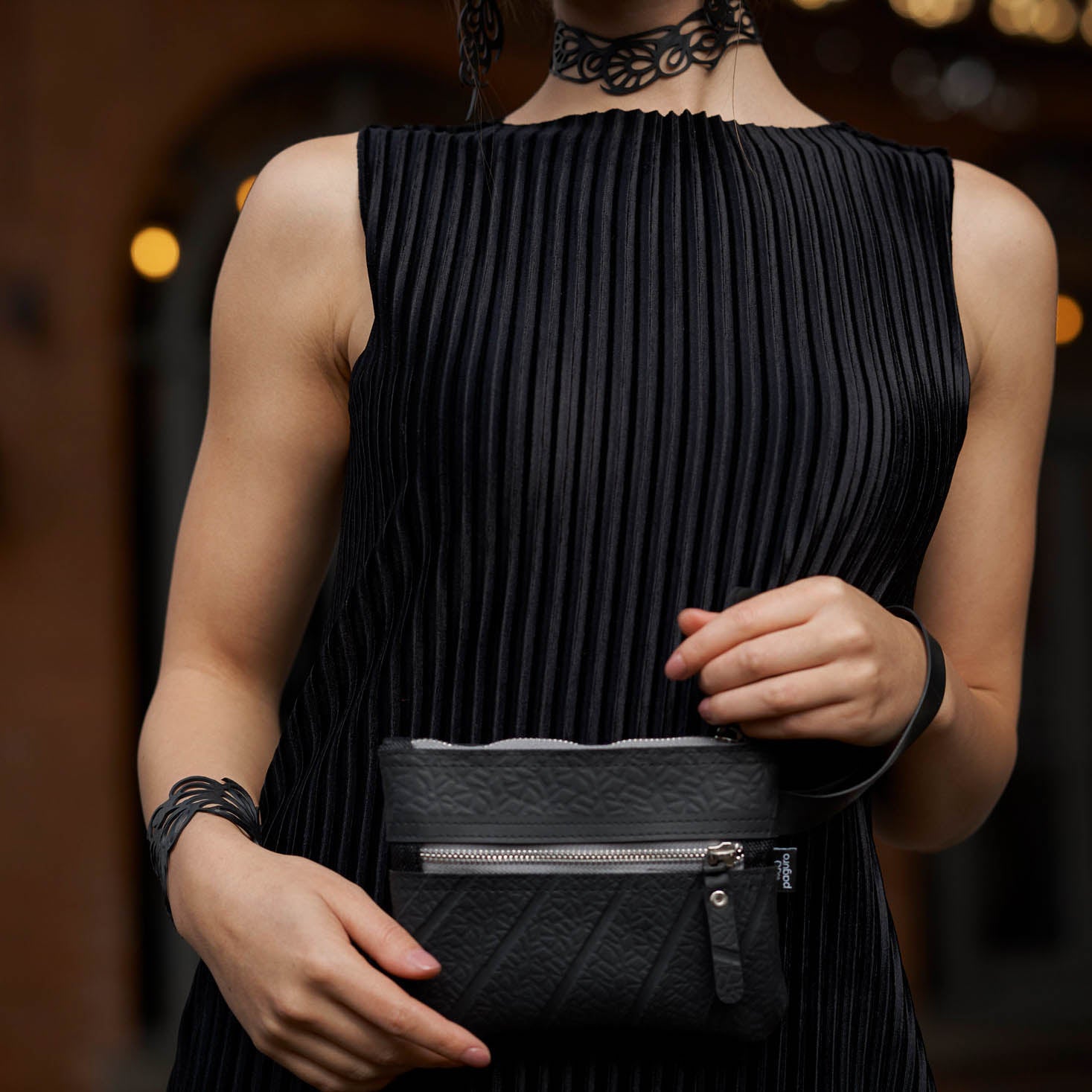 Bella Elegant Inner Tube Art Nouveau Bracelet handcrafted from recycled rubber, featuring a delicate design and button closure.