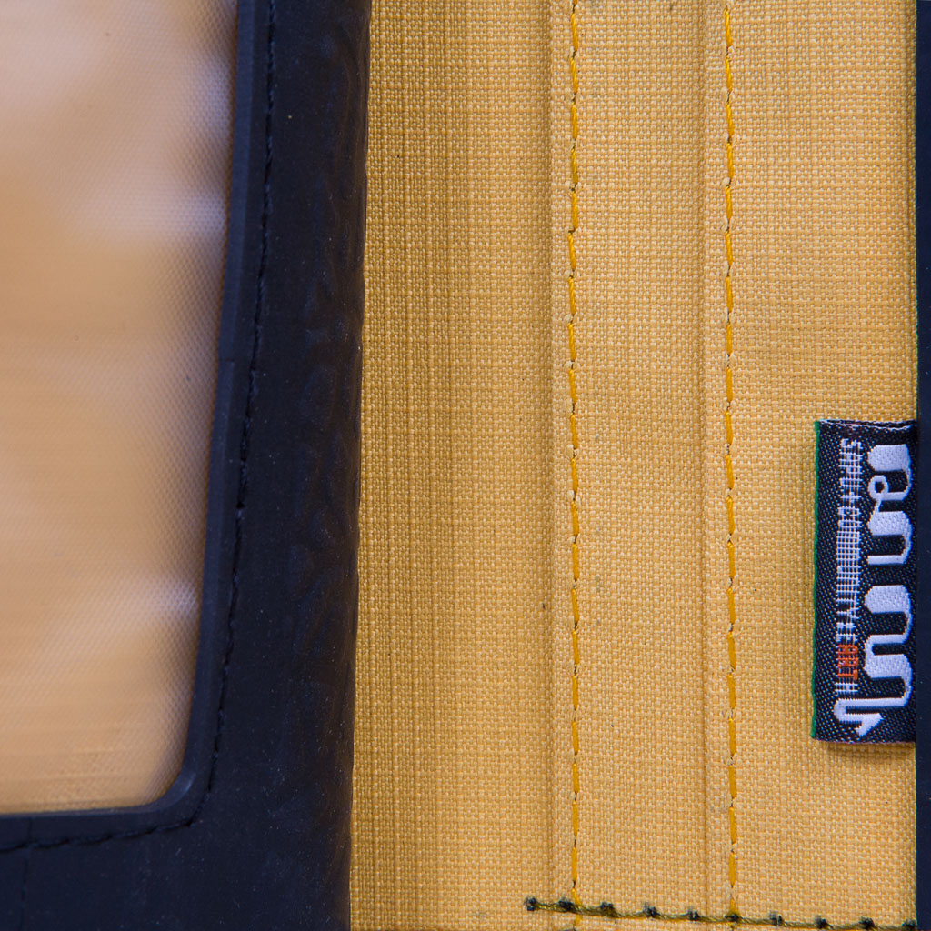 Ben Recycled Wallet with Coin Compartment, handcrafted from recycled rubber with colorful stitching, featuring multiple card slots and a zip pocket.