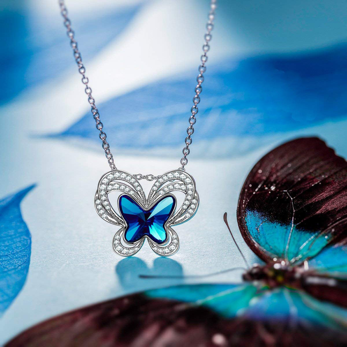 Bermuda Blue Flying Butterfly Pav'e Necklace featuring a butterfly pendant with AAAAA crystals on a 14K white gold plated link chain.