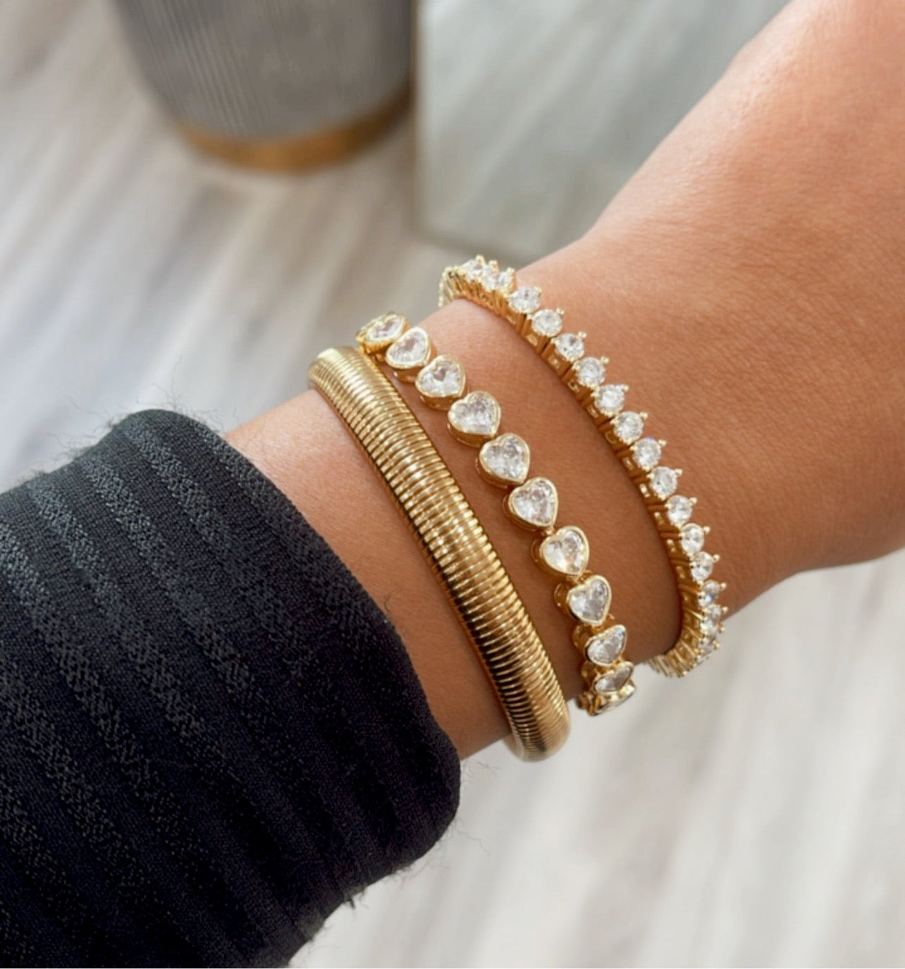 A stunning Bezel Heart Tennis Bracelet featuring a heart-shaped cubic zirconia set in 14k gold plating, perfect for everyday wear.