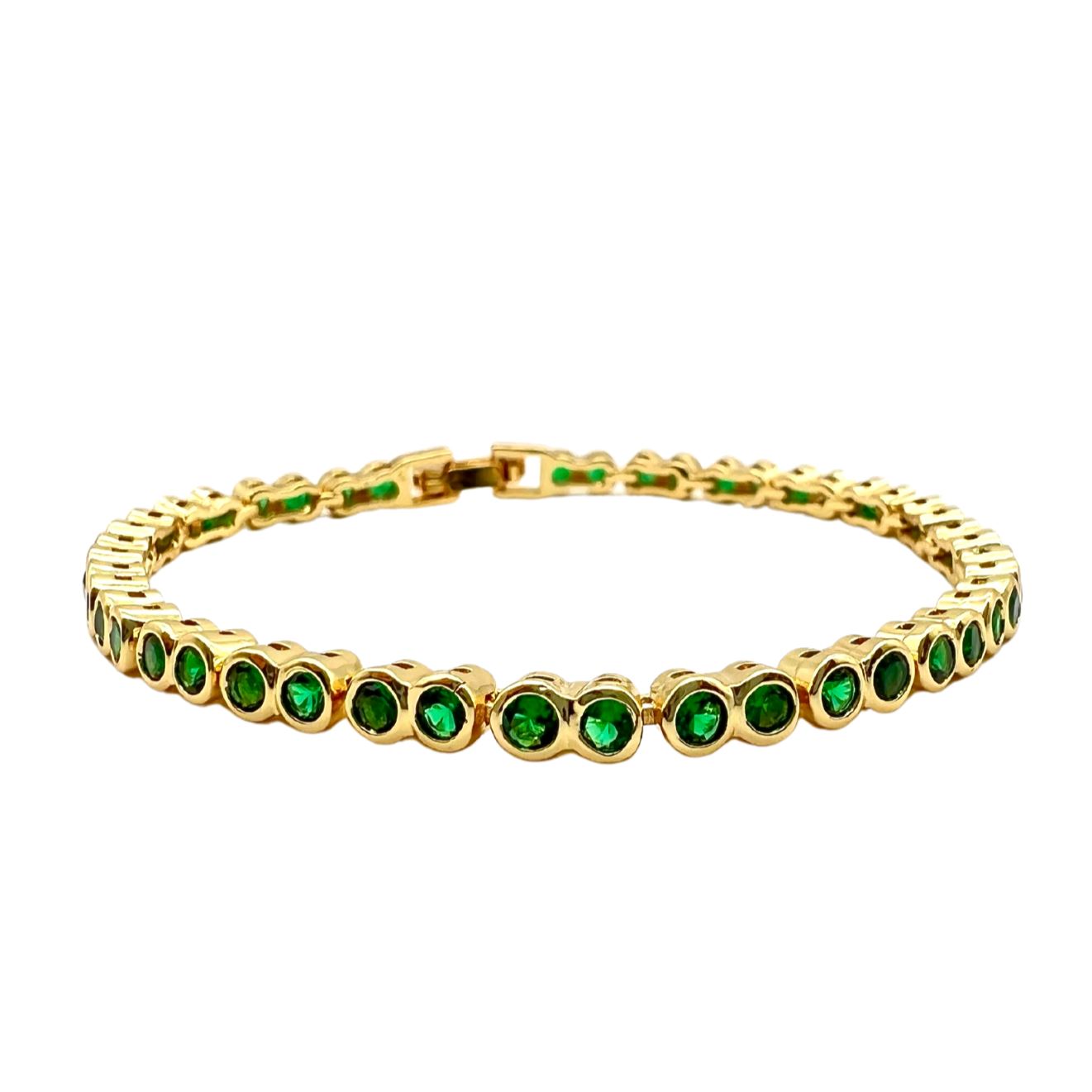 Emerald Bezel Tennis Bracelet featuring vibrant emerald stones set in a classic bezel design, perfect for stacking or wearing alone.