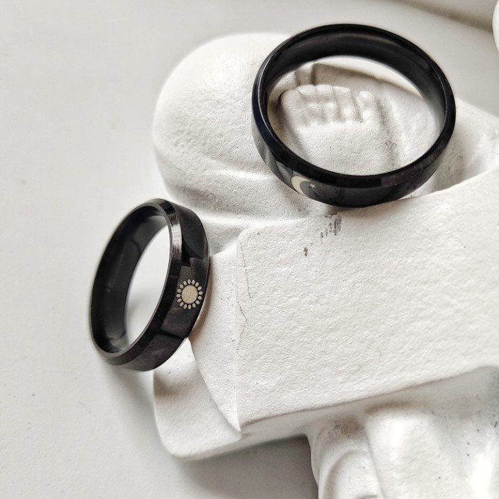 Black Band Matching Couple Moon and Sun Promise Ring set showcasing elegant sun and moon designs on durable black bands.