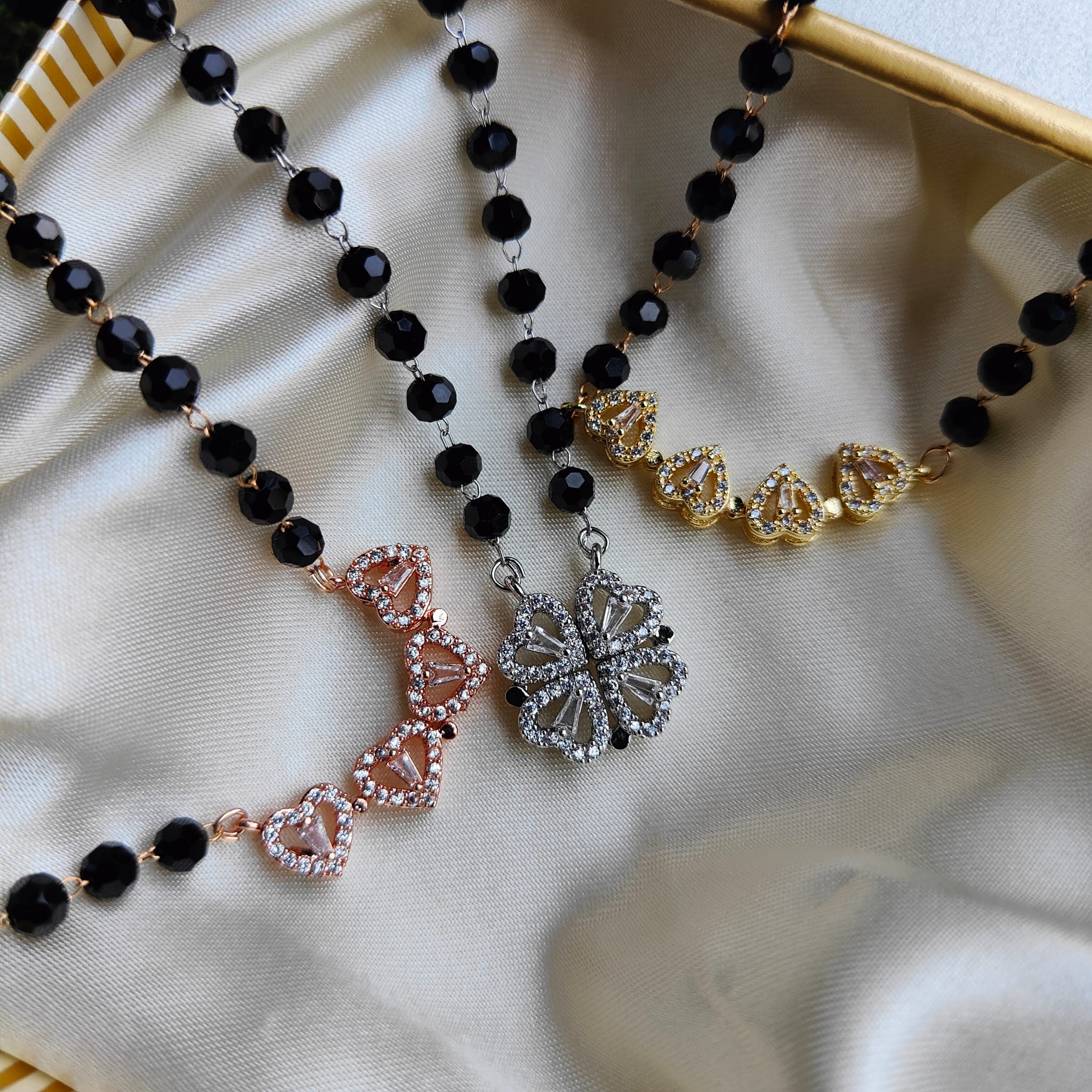 Black Bead Four Heart Magnet Foldable Zircon Mangalsutra Pendant featuring black crystal beads and a gold/silver plated finish.